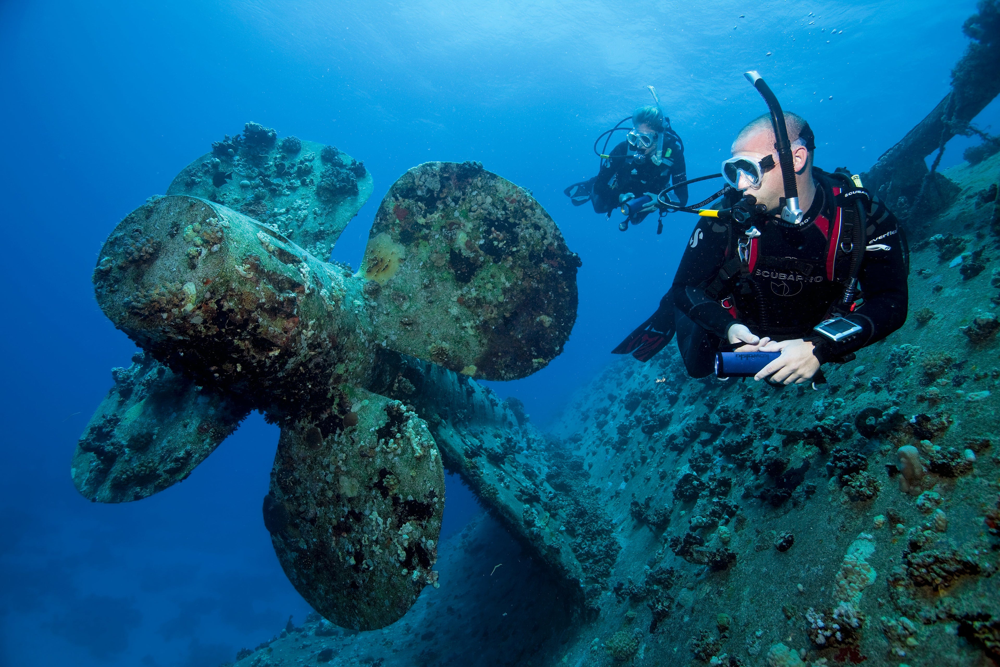 wreck diver swimming around wreck viewing ships propellor